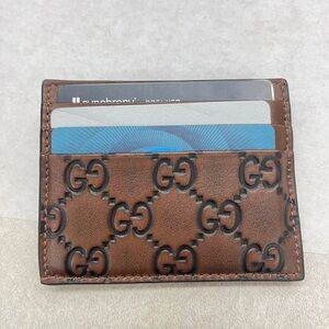 Like NEW and authentic Gucci Brown GG Embossed Leather Card Holder. Beautiful!